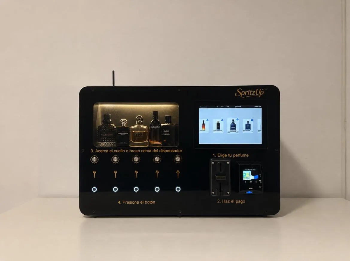 The SpritzUp machine — touchscreen, five designer perfumes on display, and contactless card payment
